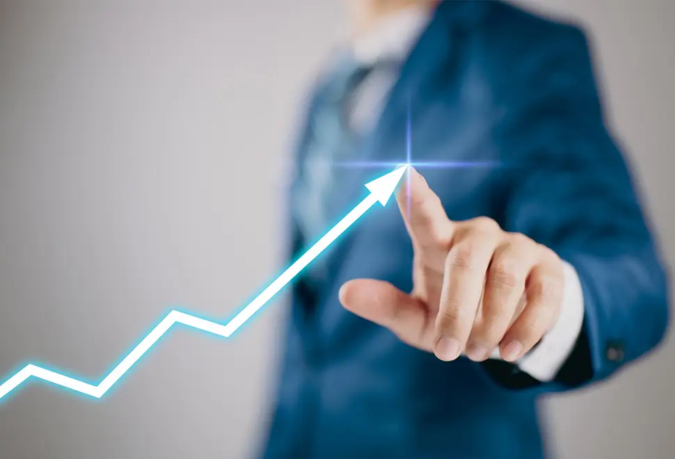 Businessperson in a suit pointing at a rising digital graph, symbolizing reliable business growth and upward performance