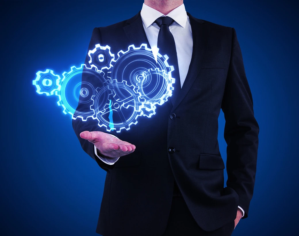 Businessman in a suit holding out his hand with glowing digital gears above his palm, symbolizing personalized service and tailored solutions.